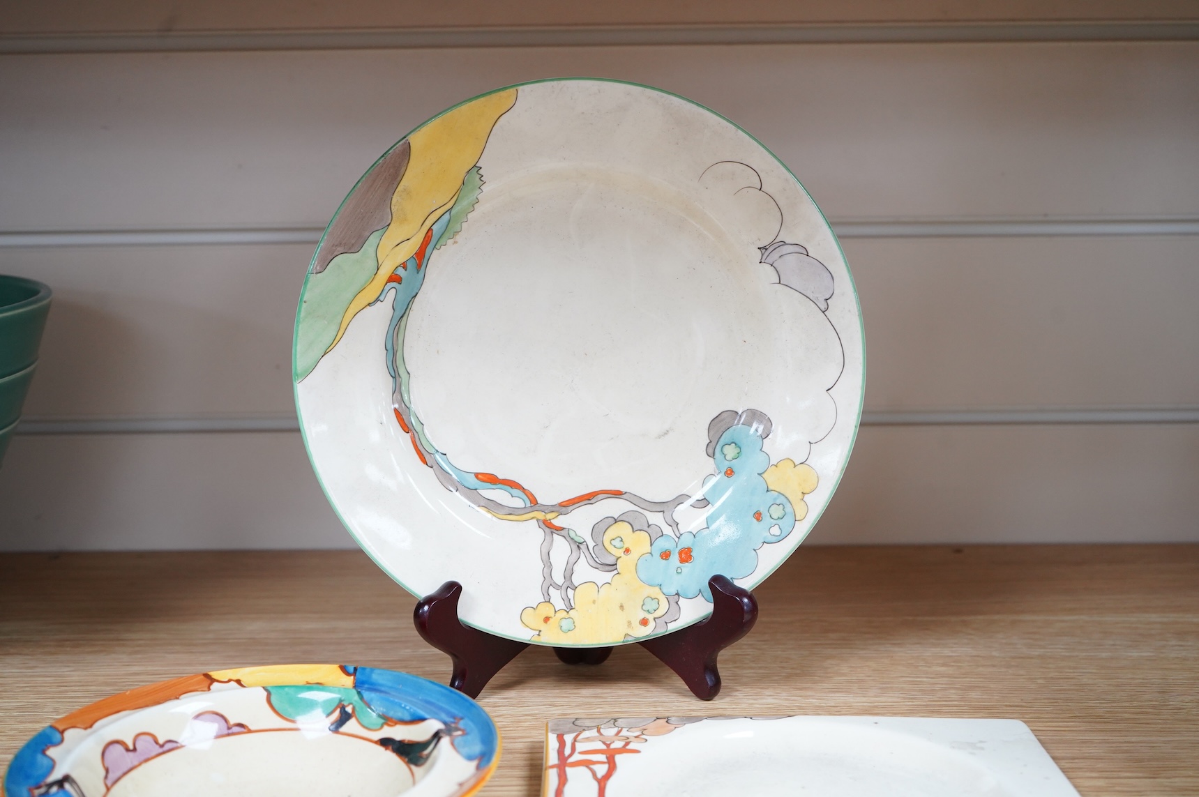 An early 20th century Clarice Cliff Bermuda pattern plate, Blue Autumn bowl and a Coral Firs Bizarre side plate, largest 23cm in diameter